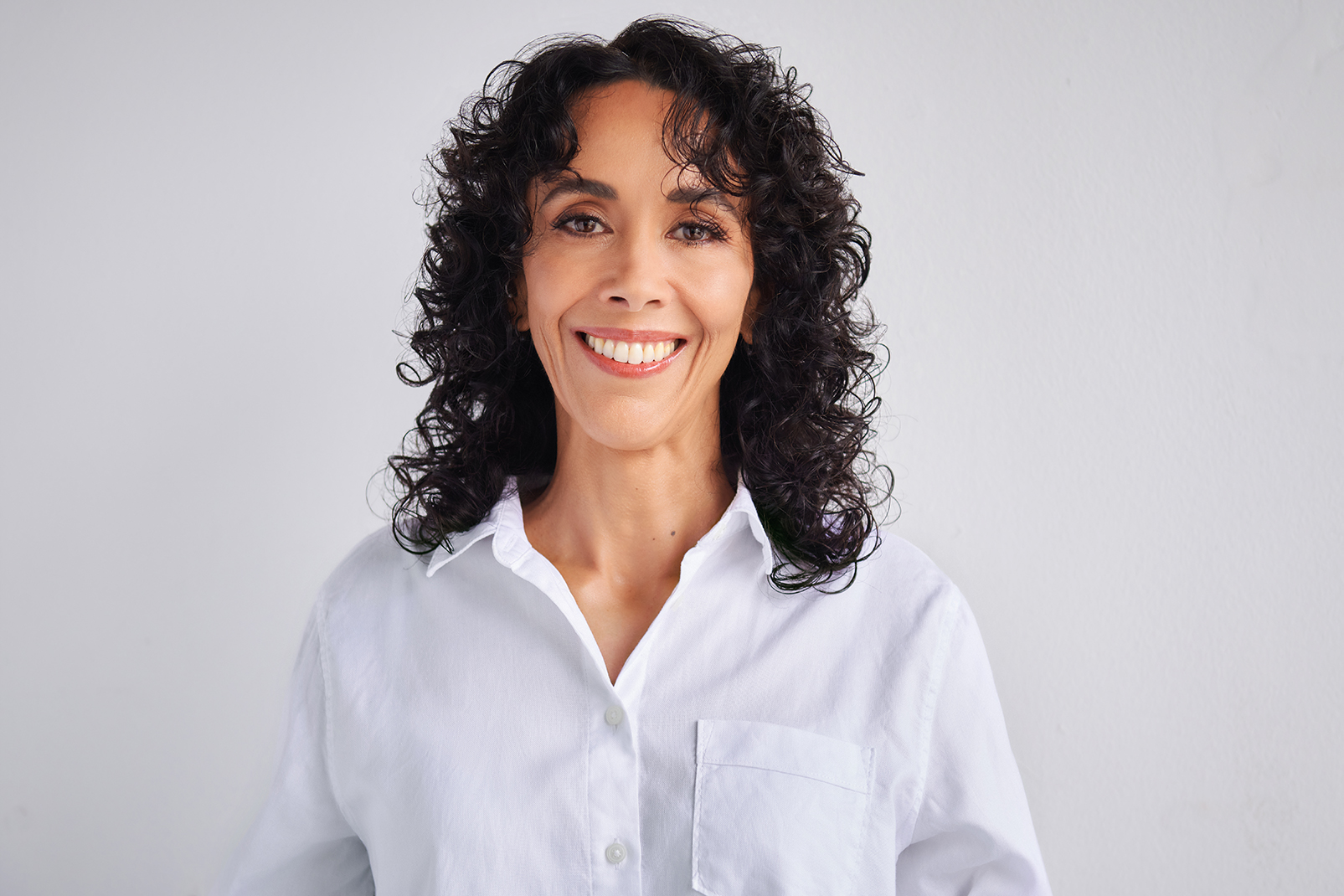 Professional woman in a white shirt against a light background