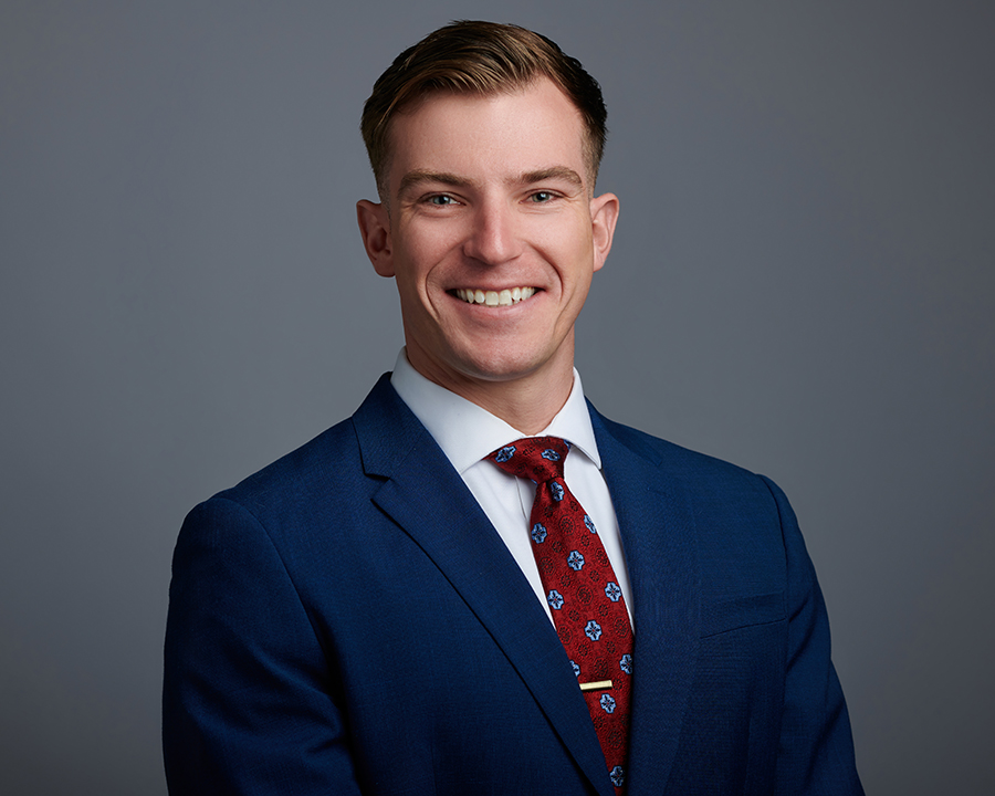 Smiling professional man in a navy suit and red tie