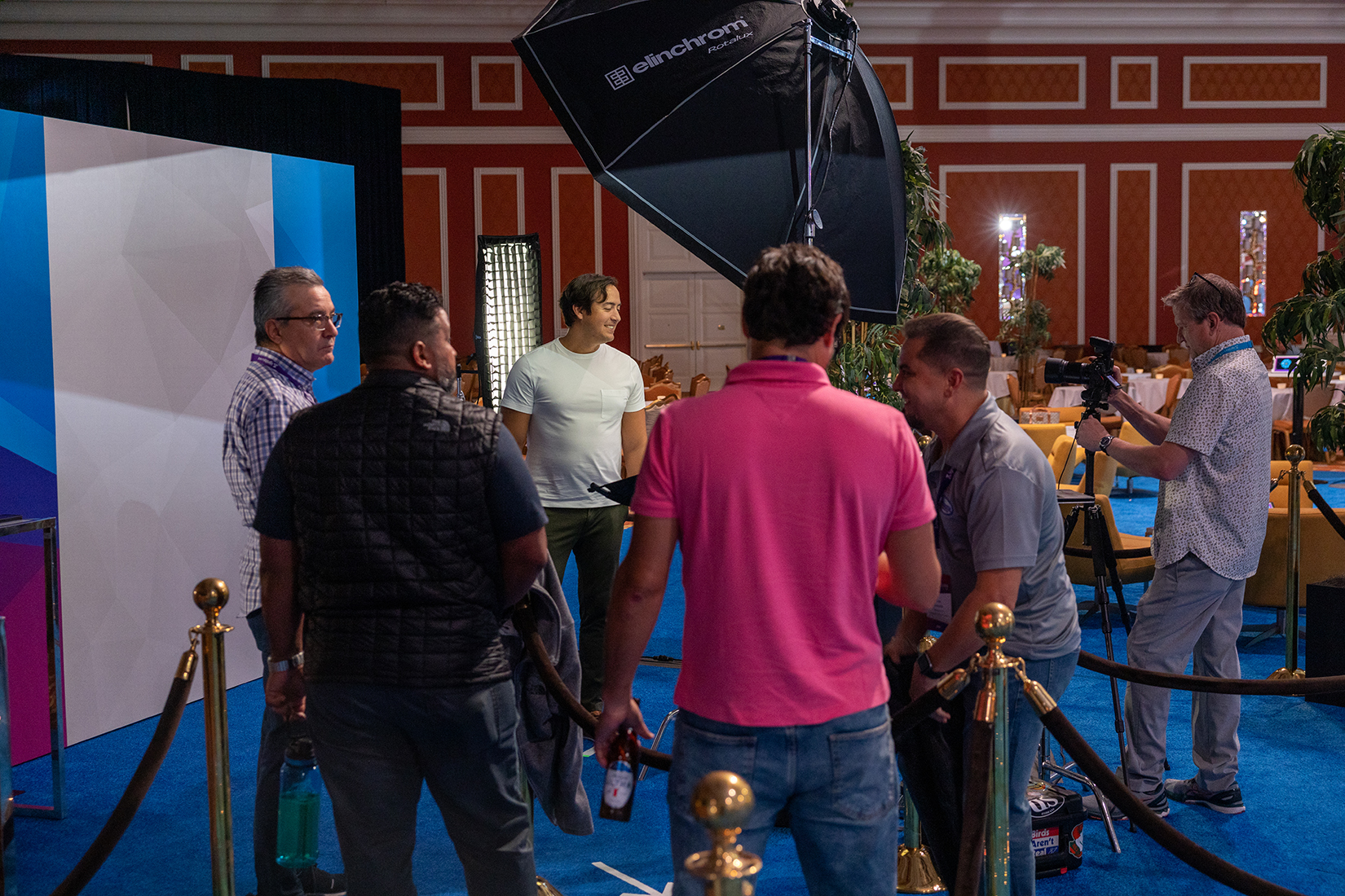 Attendees lining up at the event headshot booth between sessions