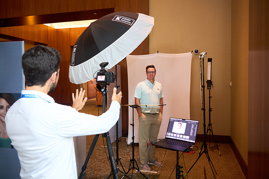 Photographer shooting a guest inside the Kemp event headshot booth